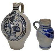 A Westerwald stoneware globular ewer, with short, slender neck and loop handle, painted with a