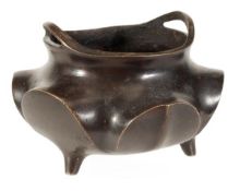 A Chinese bronze censer of lobed body raised atop three squat legs, 12cm diameter, 19th/20th