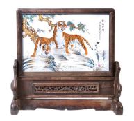 A Chinese porcelain plaque of rectangular form decorated in enamels with two tigers beneath pine