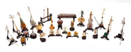 A collection of twenty-seven Chinese agate, jade and other hardstone miniature musical instruments,