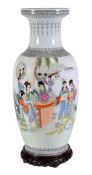 A Chinese famille rose vase of tapered ovoid form standing on a slightly flared foot and rising to