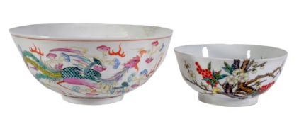 A Chinese famille rose bowl decorated with a phoenix and dragon chasing a flaming pearl amid