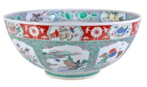 A large famille verte punch bowl of deep, circular form, decorated to the well with a roundel