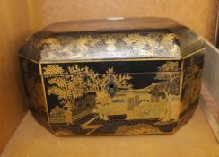 A Japanned tea caddy with fitted interior