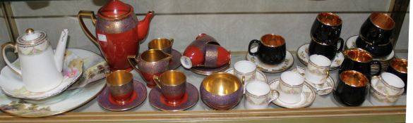 A Carlton Ware part coffee service, a Prinknash black and gilt part coffee service, a Carlton Ware