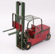 Meccano - A constructed model of a Fork-Lift Truck, fitted with an electric motor, 57cm long.