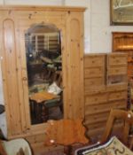 A pine wardrobe, a pair of pine bedside chests, a pine bookcase and pine chests of drawers.