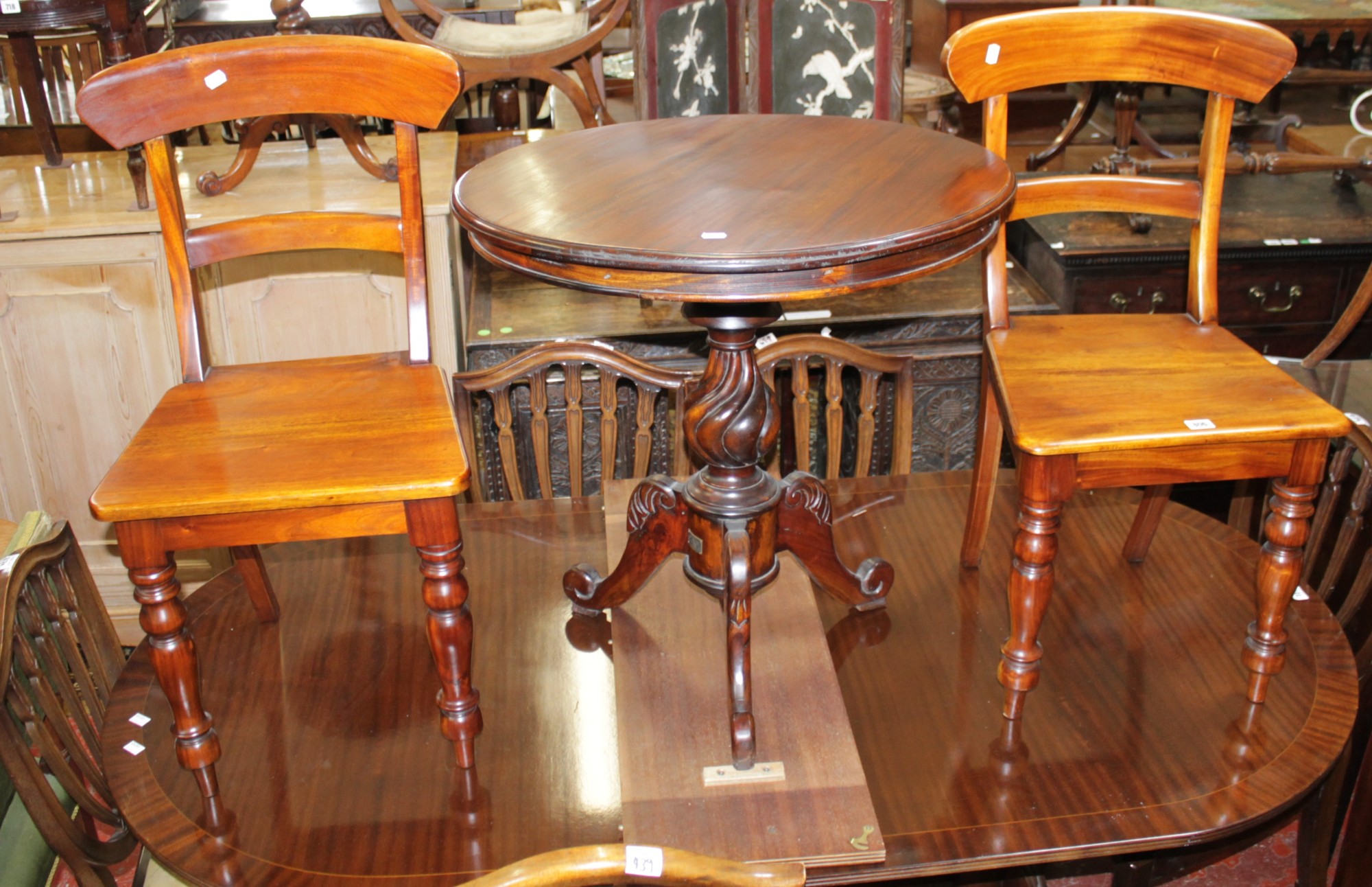 A Victorian style tripod table with circular top and a pair of Victorian style mahogany dining