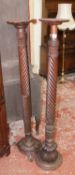 A George III style mahogany bedpost forming a torchere and a smaller one. A George III style