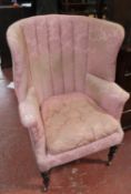 A late Georgian barrel back wing chair on ring turned support