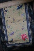 Three Japanese scrolls embroidered with birds and foliate decoration, together with a piece of paper