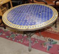 A Moroccan tile top table and a wrought iron pub base 76cm high, 98cm diameter