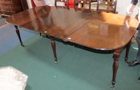 A George III mahogany extending dining table, the rounded rectangular top with reeded edge on six