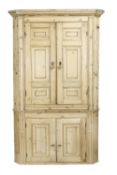 A George III pine standing corner cabinet, circa 1780, moulded cornice, two pairs of field