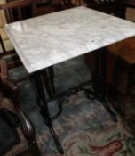 A cast iron table with marble top and a late Victorian wall mirror with shelf