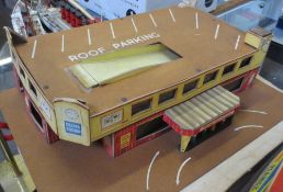 A Tri-ang Minic toy garage, of printed card and hardboard construction, fair condition (some tape