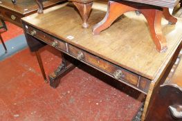 A Regency rosewood sofa table fitted two drawers on rectangular end supports on trestle ends with