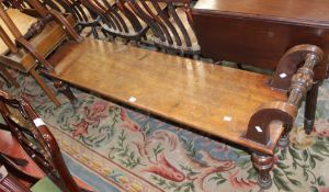 A Victorian mahogany bench with outward curved armrests 165cm length