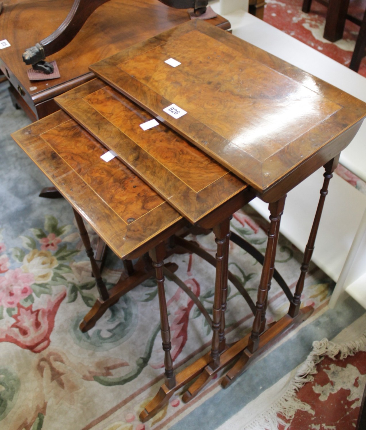 A 20th century nest of three tables together with an upholstered corner chair