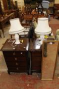 A pair of modern bedside chests and pair of modern lamps and a mirror (sold as parts)