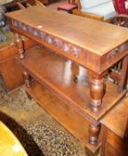 A 17th century style carved oak three tier buffet 117cm high, 122cm wide