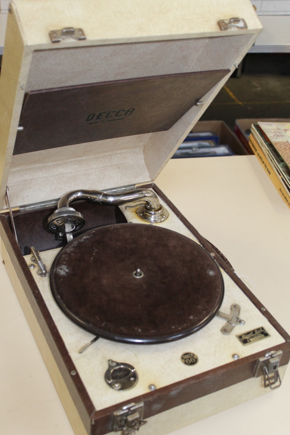A Decca 66 portable gramophone, with a Decca reproducer, in a cream and brown rexine covered case.