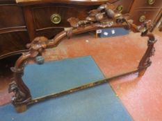 A carved overmantel mirror 134cm wide and a late 19th century mahogany and inlaid pedestal desk