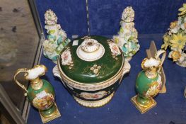 A pair of green ground ewers with handpainted fruit panels surrounded by gilt bordering (possibly