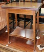 An Edwardian mahogany and satinwood crossbanded fold over top table on slender tapered legs with