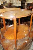 An Edwardian satinwood oval two tier table 69cm wide
