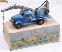 A Russian tinplate crane lorry, blue with printed detail, with a working, revolving jib, the