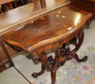 A Victorian rosewood card table with a serpentine front top on carved base 75cm high, 96cm wide,