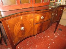 A Regency style mahogany serpentine fronted sideboard and a mahogany circular table