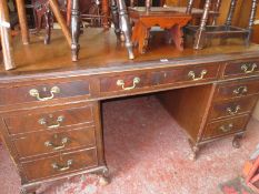 A 20th century maghogany pedestal desk with leather lined top raised on stump cabriole legs