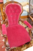 A walnut red upholstered button back low chair