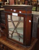 A George III style mahogany glazed hanging corner cupboard