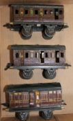 O gauge - Two Marklin L.M.S. four-wheel coaches, lined maroon livery; and a Marklin L.M.S. four-