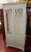 A modern painted display cabinet with arched astragal glazed doors 191cm high, 91cm wide