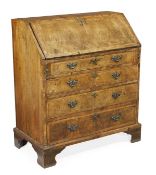 A George II walnut and crossbanded bureau, circa 1740, the fall opening to a central cupboard