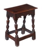 An oak joint stool, circa 1660 and later, solid plank seat, plain frieze, turned and square section