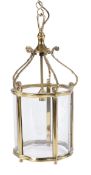 A gilt metal and glazed hall lantern, 20th century, with five bowed panes beneath five scrolling