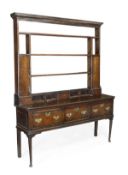 An oak dresser, second half 18th century, dentil moulded cornice, an arrangement of six open