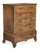 A George III oak chest on stand, circa 1780, rectangular top, two short and three long drawers, the