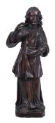 A carved and stained oak model of a robed man, late 17th century, portrayed standing, his long