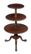 A George III mahogany three tier dumb waiter, circa 1780, each circular tier with cabochon carved