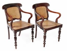 A pair of Colonial hardwood and caned chairs, 19th century, shaped backs, caned central back and