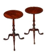 A pair of mahogany tripod tables, George III style, circular tops with moulded edge, acanthus