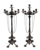 A pair of French patinated bronze six light candelabra in the ‘Pompeiian’ taste, circa 1875, each