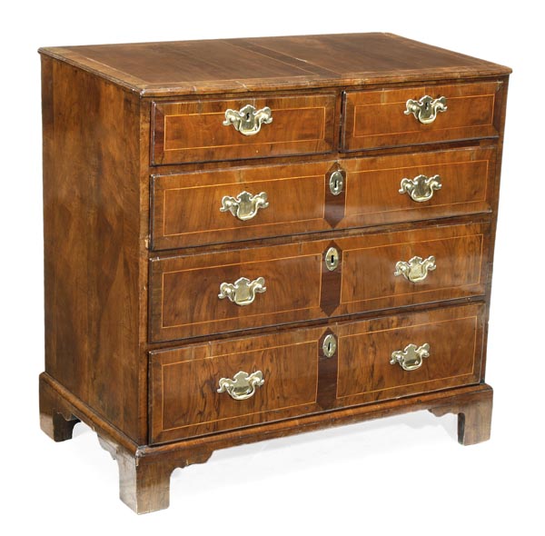 A George II walnut chest of drawers, circa 1735, inlaid with holly stringing throughout,