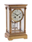 A French gilt brass and champleve enamel four glass mantel clock Unsigned, circa 1900 The eight-